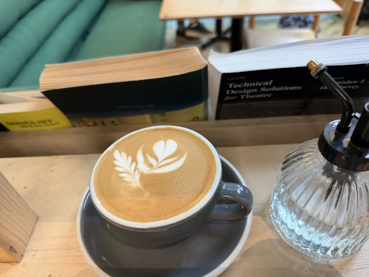 Creative leaf and heart latte art in a grey cup